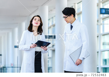 病院でミーティングする白衣を着た男女の医療イメージ 72532463