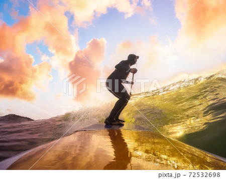 Adventurous Man Surfing the waves at the Pacific Ocean Adventurous Man Surfing the waves at the Pacific Ocean 72532698