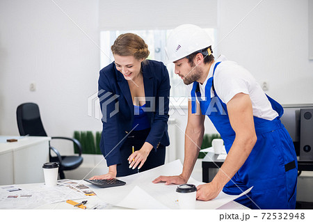 A young male architect discussing the construction project with 72532948
