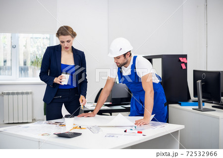 A young male architect discussing the construction project with 72532966