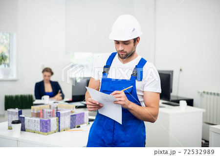 A portrait of a handsome construction engineer taking notes whil A portrait of a handsome construction engineer taking notes whil 72532989