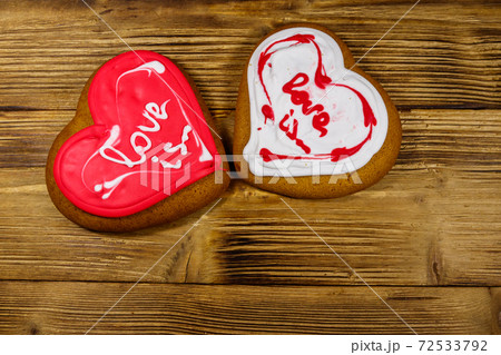 Heart shaped gingerbread cookies on wooden table. Top view. Dessert for valentine day Heart shaped gingerbread cookies on wooden table. Top view. Dessert for valentine day 72533792