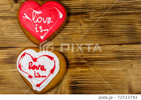 Heart shaped gingerbread cookies on wooden table. Top view, copy space. Dessert for valentine day Heart shaped gingerbread cookies on wooden table. Top view, copy space. Dessert for valentine day 72533793