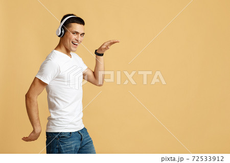 Dancing and fun with favorite music. Happy excited young male student dancing Dancing and fun with favorite music. Happy excited young male student dancing 72533912