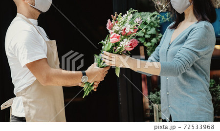 Florist owner of small business holding flowers for delivery to customers at store Florist owner of small business holding flowers for delivery to customers at store 72533968