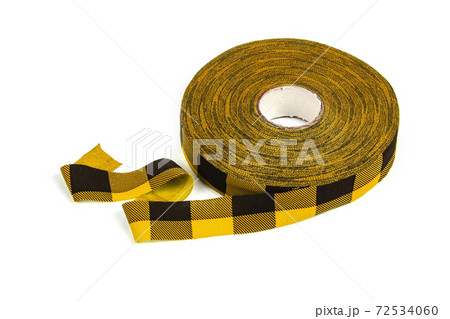 elastic knitted tape yarn for crochet on white background rolled up. 72534060