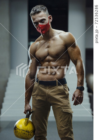 Caucasian man exercising in gym wearing a mask Caucasian man exercising in gym wearing a mask 72536286