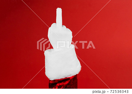 Fucking 2020 year. The concept of a bad new year or christmas. Harsh emotion painted on the middle finger of Santa hand 72536343