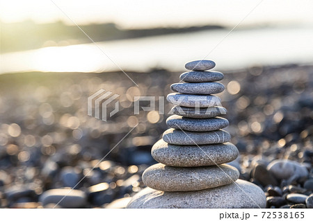 Pyramid of gray pebble stones on the beach of Turkey at sunrise. Zen concept, relaxation. calmness Pyramid of gray pebble stones on the beach of Turkey at sunrise. Zen concept, relaxation. calmness 72538165