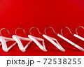 White hangers on a red background. Sales clothes concept. 72538255