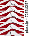 White hangers on a red background. Sales clothes concept. 72538257