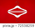White hangers on a red background. Sales clothes concept. 72538259