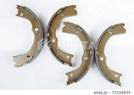 kit of drum brake pads with asbestos alloy on steel car spare parts isolated on white background side view. kit of drum brake pads with asbestos alloy on steel car spare parts isolated on white background side view. 72538634