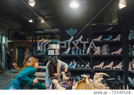 People carefully work on clay whales in workshop People carefully work on clay whales in workshop 72540528
