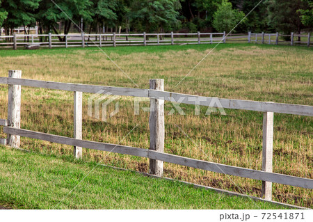 wooden fence pasture agriculture on the sidelines with green grass, nobody and no animals. 72541871