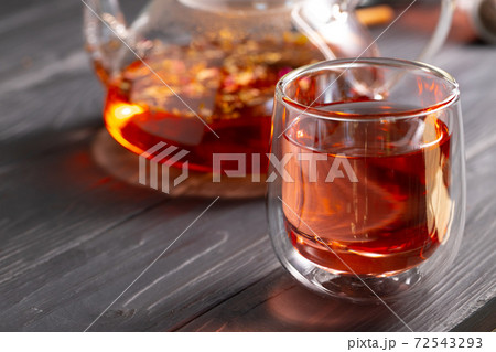 Glass tea cup and teapot on table Glass tea cup and teapot on table 72543293