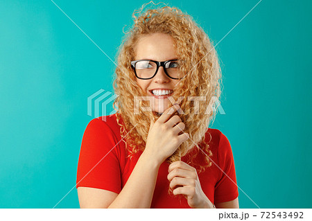 Joyful young curly woman in glasses smiling Joyful young curly woman in glasses smiling 72543492