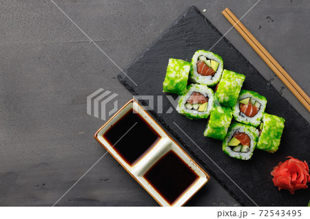 Top view of California sushi roll in plate on black background Top view of California sushi roll in plate on black background 72543495