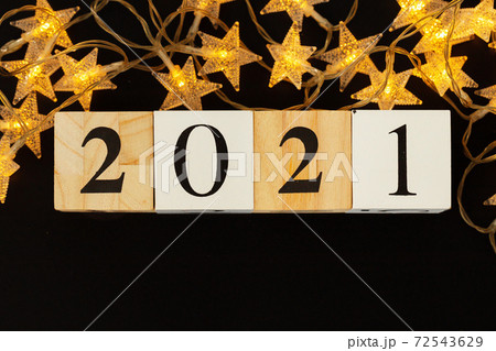 Concept of the year 2021. Golden stars with 2021 numbers on paper background Concept of the year 2021. Golden stars with 2021 numbers on paper background 72543629