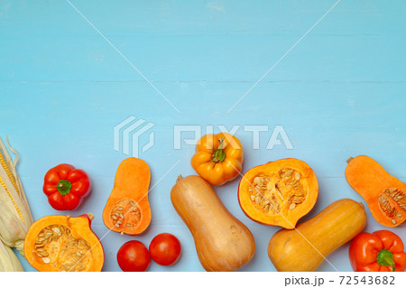 Variety of vegetables including pumpkins on blue pastel background 72543682
