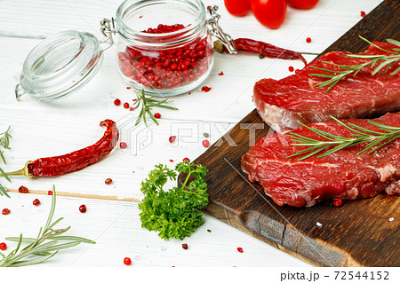 Barbecue veal steaks with rosemary on wooden board 72544152