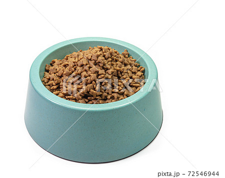 The close up of dry dog treat food in blue green plastic dog bowl, pet equipment isolated on white background. 72546944