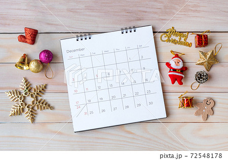 December calendar and Christmas decoration - Santa Clause and gift on wooden table. Christmas and Happy new year concept 72548178
