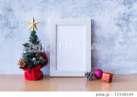 Picture frame and Christmas decoration - Santa Clause and gift on wooden table. Christmas and Happy new year concept 72548194