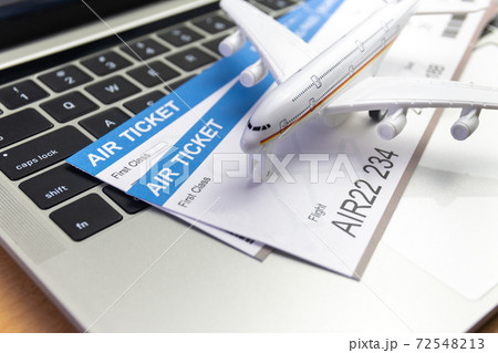 laptop computer and airplane and money on table. Online ticket booking concept 72548213