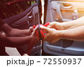 Man fixing car dent by himself 72550937