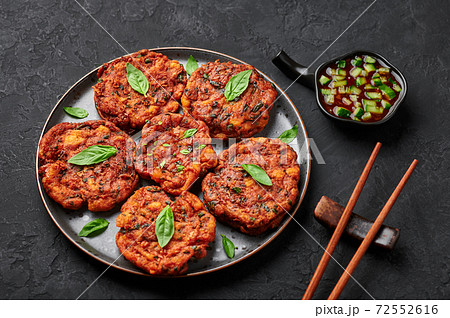 Tod Mun Pla or Thai Fish Cakes on black plate on slate table top. Traditional Thailand cuisine dish 72552616