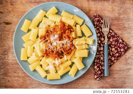 Above view of beautiful tasty pasta food with tomatoes ragu and parmigiano cheese - concept of italian food restaurant or home kitchen - single life image Above view of beautiful tasty pasta food with tomatoes ragu and parmigiano cheese - concept of italian food restaurant or home kitchen - single life image 72553281