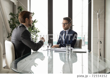 Serious businessmen discuss business ideas at office meeting 72554352