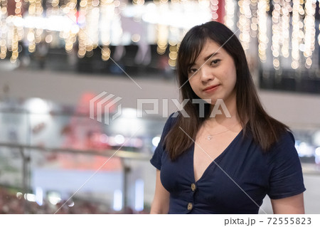 Beautiful Asian woman smiling with bokeh background. 72555823