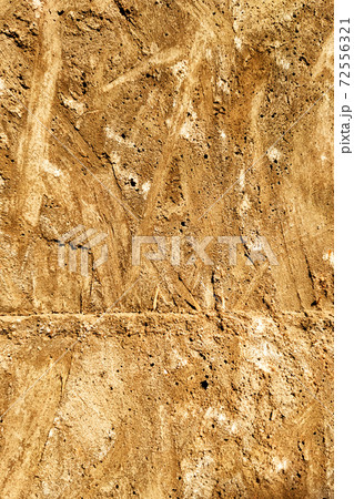 The imprint on a concrete is a texture of wooden plywood orange-yellow color The imprint on a concrete is a texture of wooden plywood orange-yellow color 72556321