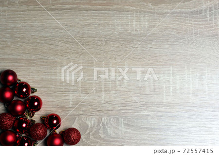 Christmas and New Year template with red balls on light oak wood textured surface with copy space Christmas and New Year template with red balls on light oak wood textured surface with copy space 72557415