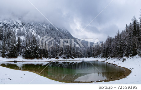 Green lake Gruner see cloudy winter day. Famous tourist destination. 72559395