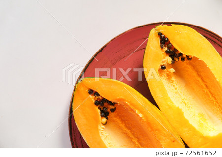 close up of slice of papaya on plate  72561652