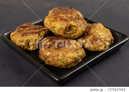 Homemade meat beef burger patties cutlet heap on black plate table background. Keto diet concept Homemade meat beef burger patties cutlet heap on black plate table background. Keto diet concept 72562562