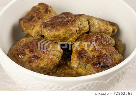 Homemade meat beef burger patties cutlet heap on white plate table background. Ketogenic diet 72562563
