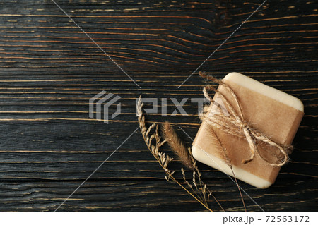Pieces of natural handmade soap on wooden background 72563172
