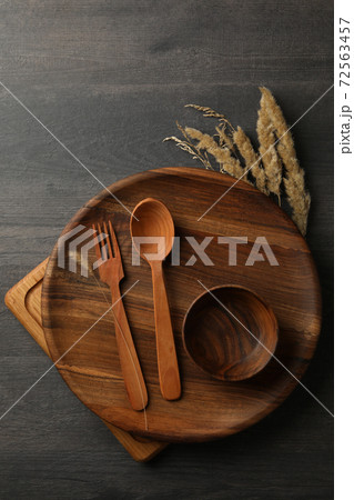Different wooden kitchenware on dark table, top view Different wooden kitchenware on dark table, top view 72563457