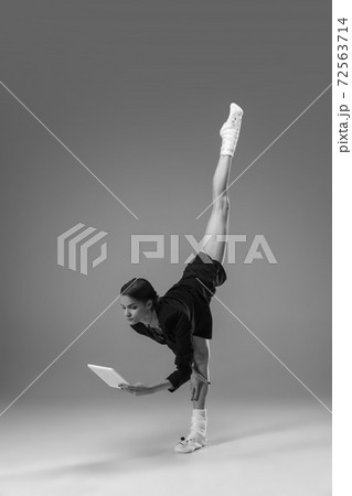 Young fashionable, stylish woman wearing jacket and socks working from home. Fashion during insulation 'cause of coronavirus pandemic Young fashionable, stylish woman wearing jacket and socks working from home. Fashion during insulation 'cause of coronavirus pandemic 72563714