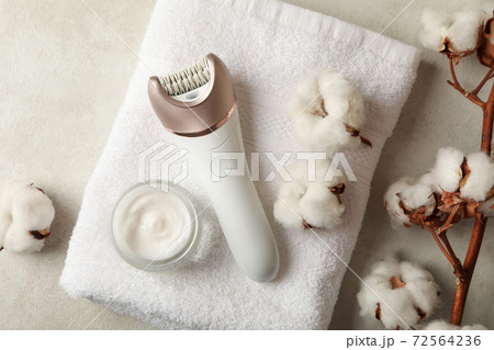 Towel, epilator, cotton and cream on white background Towel, epilator, cotton and cream on white background 72564236