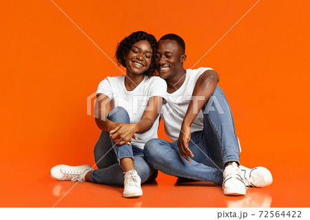 Loving black man and woman having fun, studio shot 72564422