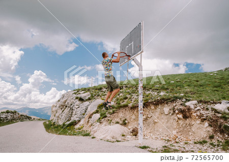 man playing basketball at countryside man playing basketball at countryside 72565700