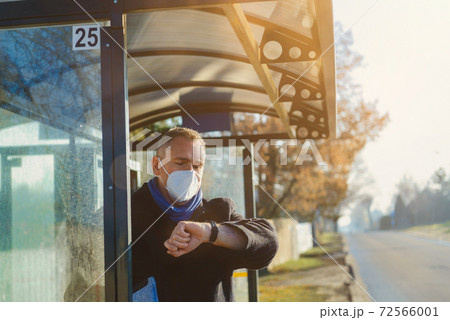 Man stands at the bus stop Man stands at the bus stop 72566001