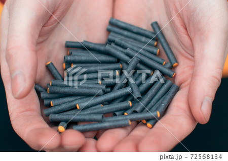 Man Holding Small Firecrackers in his Hand Man Holding Small Firecrackers in his Hand 72568134