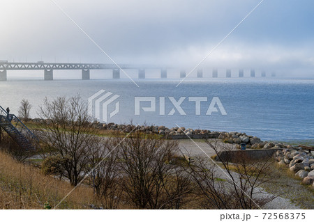 A bridge in fog. Blue ocean and mist in the background. Picture from the bridge connecting Sweden with Denmark 72568375