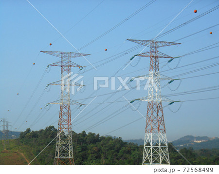 SEREMBAN, MALAYSIA -JUNE 16, 2017: High tension steel pylon transmitting high voltage electrical power to the consumer. SEREMBAN, MALAYSIA -JUNE 16, 2017: High tension steel pylon transmitting high voltage electrical power to the consumer. 72568499